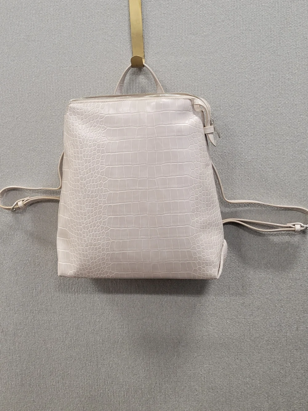 A chic and versatile cream faux‑croc mini backpack from Target’s a new day line.
